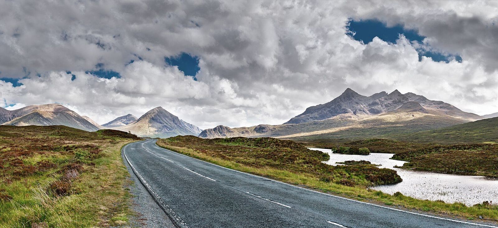 An empty road on the Isle of Skye leading toward the Cuillin mountains